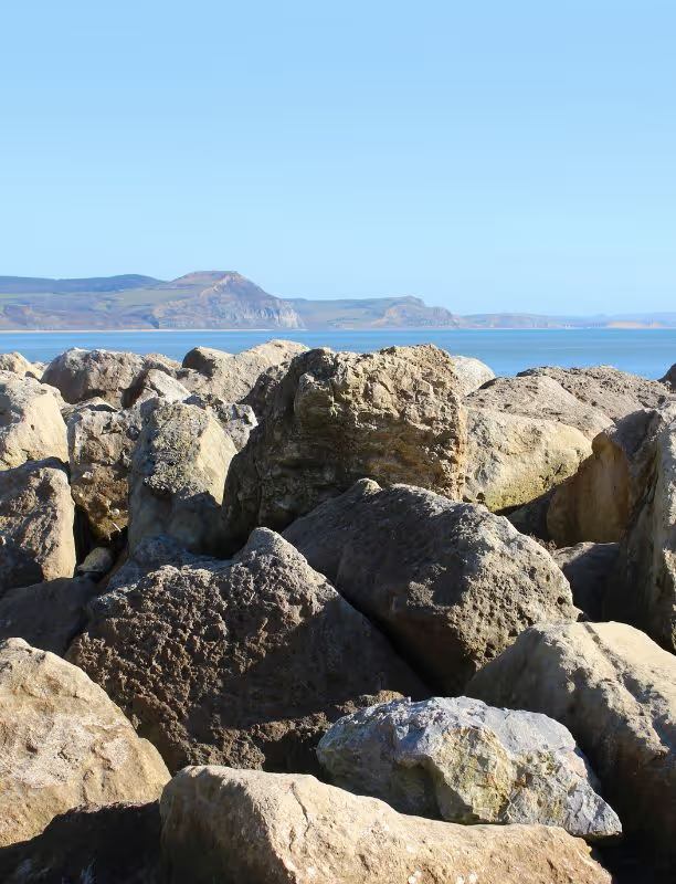 Large landscape boulders stacked near the coast